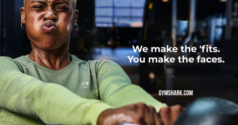 Runner Oyinda Okunowo swinging a kettlebell for a Gymshark ad that has 2 lines of text overlay along with the link to its website.